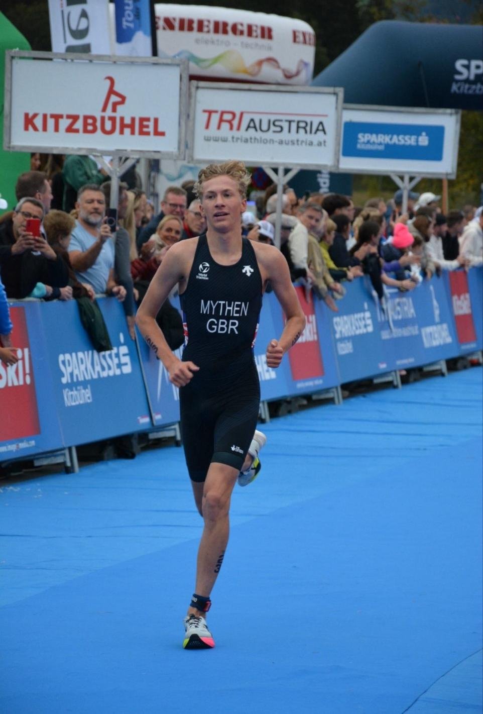 Tom Mythen running in a GBR triathlon suit in Austria